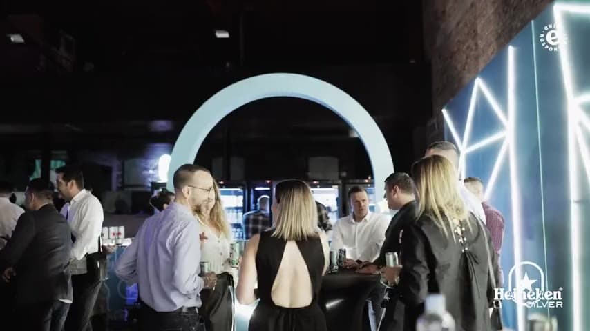 Guests at the Heineken Silver launch event inside a branded industrial venue at night